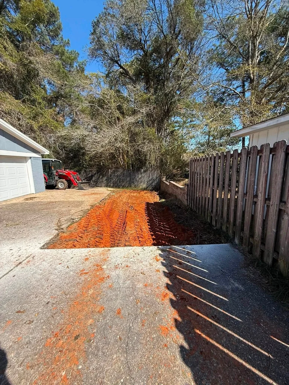 Driveway ground preparation beside a home